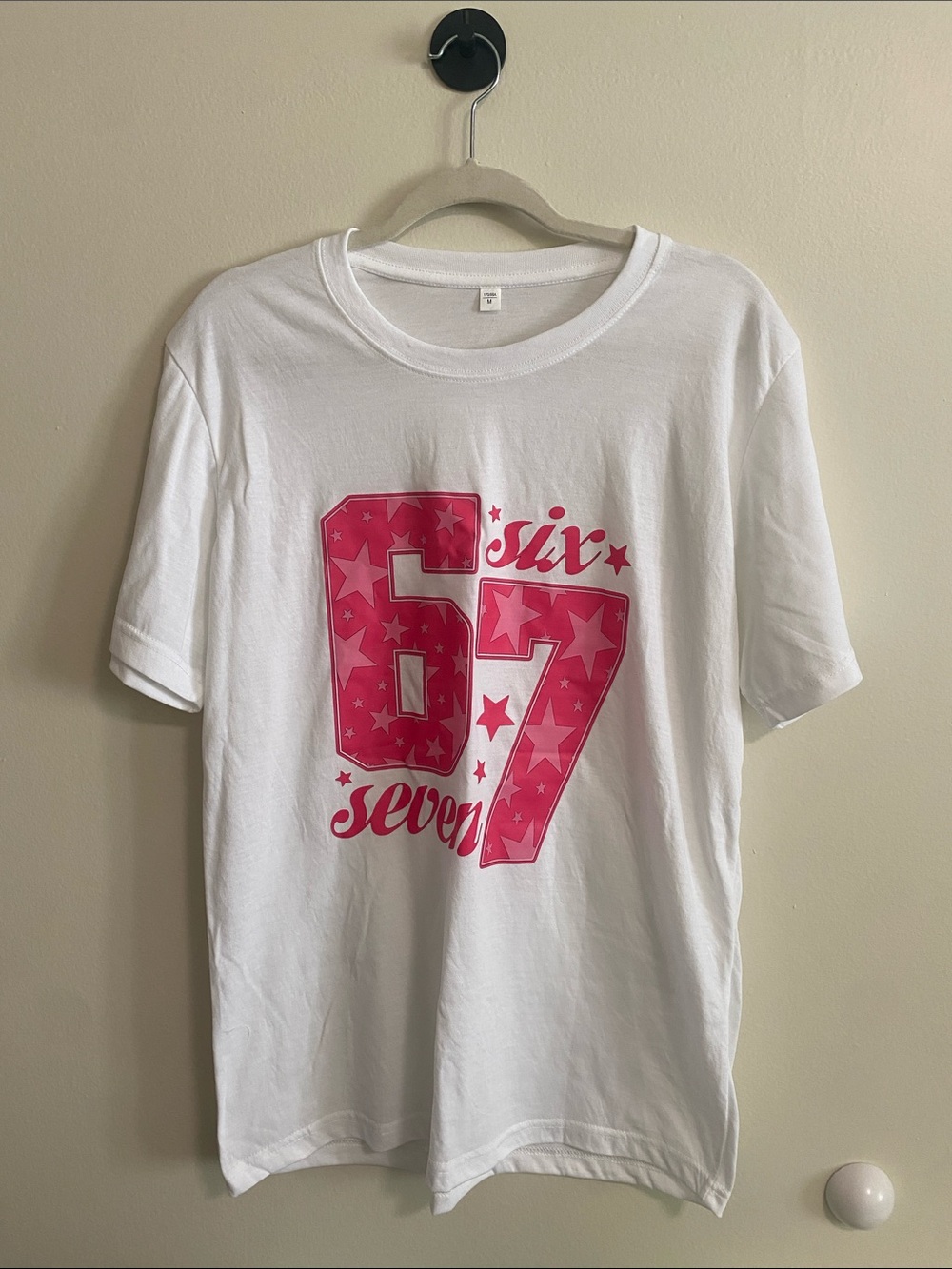 White Graphic Tee with Pink "67" Star Design